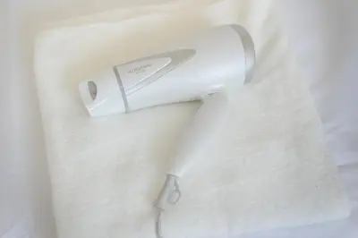 a hair dryer sitting on top of a white shirt at Downtown Mix in Tokyo
