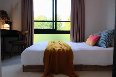 a bedroom with a bed with a blanket on it at Mi-HOTEL ATELIER SHINJUKU in Tokyo