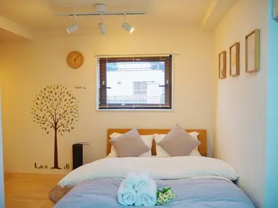 a bedroom with a bed with a tree on the wall at Subway 2min Skytree#6min Asakusa in Tokyo