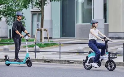 a man and a woman riding on scooters on the street at Subway 2min Skytree#6min Asakusa in Tokyo