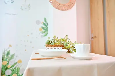 a table with two white bowls and a plant at Subway 2min Skytree#6min Asakusa in Tokyo
