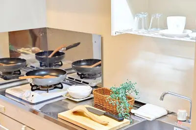 a kitchen with four pots and pans on a stove at Subway 2min Skytree#6min Asakusa in Tokyo