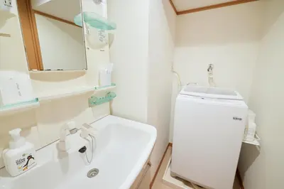 a bathroom with a sink and a toilet and a mirror at Est Stay KOIWA - Private Tokyo Apartment with Easy Access to Airport and Popular Attractions in a Calm and Friendly Neighborhood in Tokyo