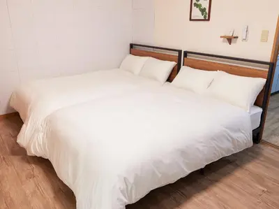 two beds sitting next to each other in a room at Est Stay KOIWA - Private Tokyo Apartment with Easy Access to Airport and Popular Attractions in a Calm and Friendly Neighborhood in Tokyo