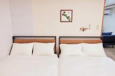 two beds in a room with a cross on the wall at Est Stay KOIWA - Private Tokyo Apartment with Easy Access to Airport and Popular Attractions in a Calm and Friendly Neighborhood in Tokyo