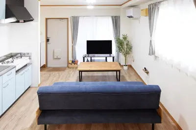 a living room with a blue couch and a table at Est Stay KOIWA - Private Tokyo Apartment with Easy Access to Airport and Popular Attractions in a Calm and Friendly Neighborhood in Tokyo