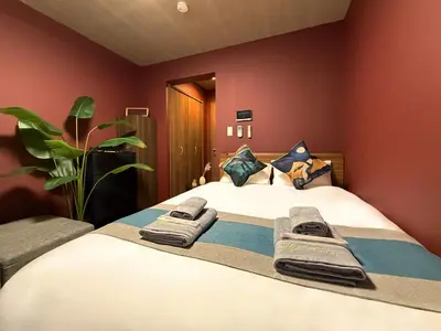 a bedroom with a bed with towels on it at nestay apartment tokyo komagome in Tokyo