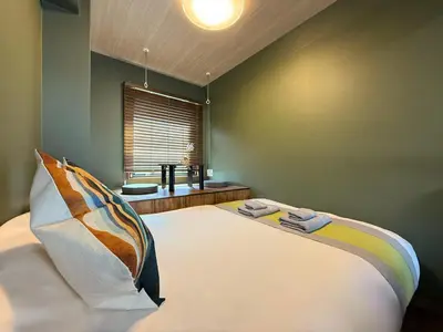 a bedroom with a large bed with a window at nestay apartment tokyo komagome in Tokyo