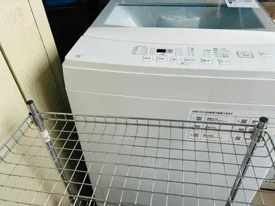 a washing machine is sitting next to a shopping cart at \u6c60\u888bHouse2F Cozy for 1-3 guests in Tokyo