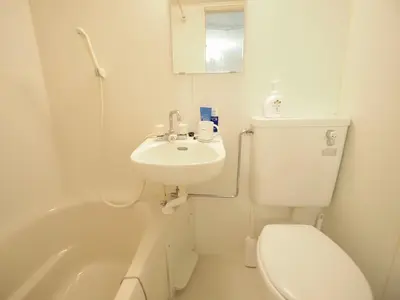 a bathroom with a toilet and a sink and a tub at UENO 704 jellynehouse in Tokyo