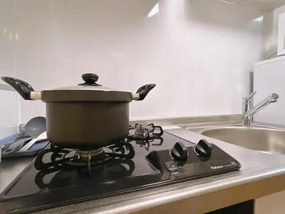 a pot on top of a stove in a kitchen at \u6c60\u888bHouse1F 2bedrooms suite Cozy for 1-4 guests in Tokyo