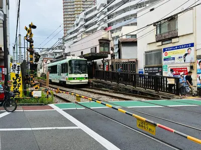a train is coming down the tracks in a city at \u6c60\u888bHouse1F 2bedrooms suite Cozy for 1-4 guests in Tokyo