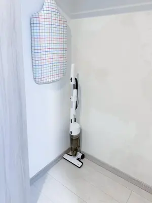 a room with a white wall with a white machine at Triphome Shinjuku East in Tokyo