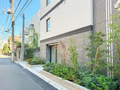 a brick building with plants on the side of it at Triphome Shinjuku East in Tokyo
