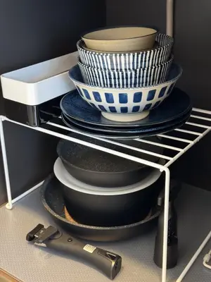 a stack of plates and bowls on a shelf at Triphome Shinjuku East 4F in Tokyo