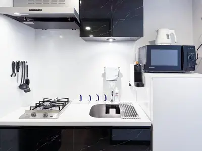 a kitchen with a sink and a microwave at Triphome Shinjuku East 4F in Tokyo