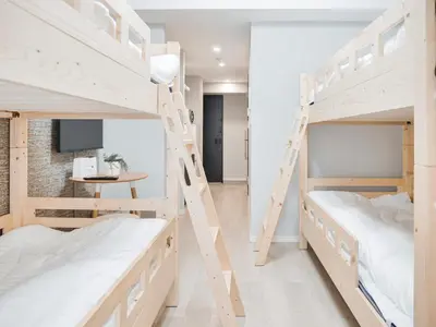 a room with two bunk beds and a table at Triphome Nakano 2025 Bunk bed in Tokyo