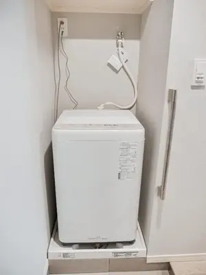 a toilet in a bathroom with a phone on top of it at Triphome Nakano 2025 Bunk bed in Tokyo