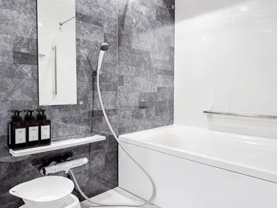 a bathroom with a tub and a toilet and a sink at Triphome Nakano 2025 Bunk bed in Tokyo