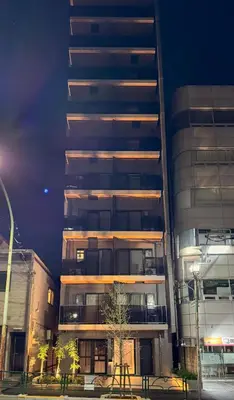 a tall building with a tree in front of it at Triphome Nakano 2025 Green in Tokyo