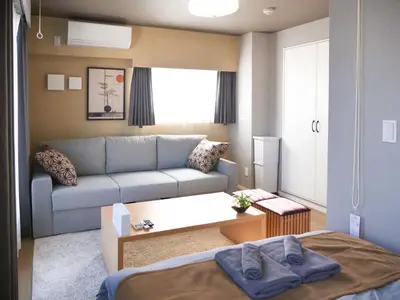 a small living room with a couch and a bed at Triphome Nakano 2025 Penthouse in Tokyo
