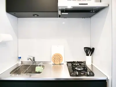 a kitchen with a sink and a stove top oven at Triphome Nakano 2025 Penthouse in Tokyo