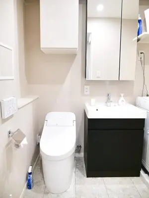 a bathroom with a white toilet and a sink at Triphome Nakano 2025 Penthouse in Tokyo