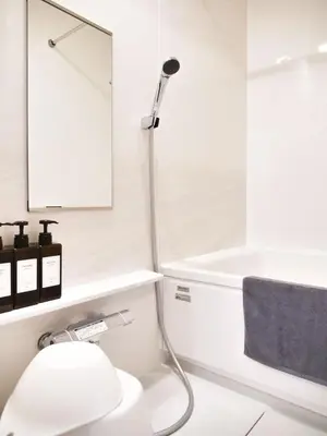 a white bathroom with a shower and a toilet at Triphome Nakano 2025 Penthouse in Tokyo