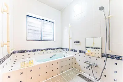 a bathroom with a tub and a window at Poka villa aoyama - Vacation STAY 19050 in Tokyo
