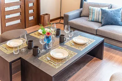 a table with plates and glasses on it in a living room at Poka villa aoyama - Vacation STAY 19050 in Tokyo