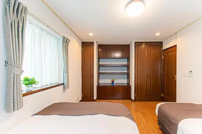 a bedroom with two beds and a window at Poka villa aoyama - Vacation STAY 19050 in Tokyo