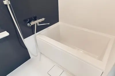 a white bath tub in a bathroom with a sink at Miraisya Hikifune in Tokyo