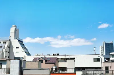 a view of a city with buildings and a blue sky at Miraisya Hikifune in Tokyo