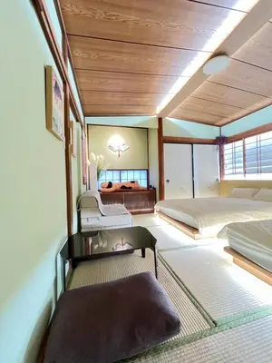 a bedroom with two beds and a couch at Takara\u8c4a\u5cf6\u5712101 NR0434 in Tokyo
