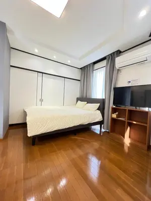 a bedroom with a bed and a flat screen tv at Takara\u8c4a\u5cf6\u5712101 NR0434 in Tokyo