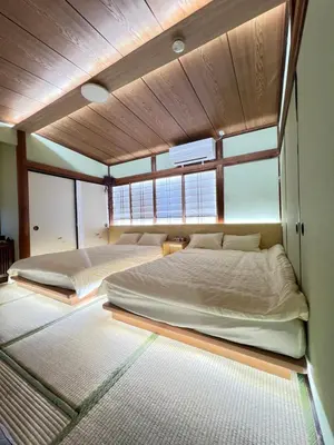 two beds in a large room with windows at Takara\u8c4a\u5cf6\u5712101 NR0434 in Tokyo