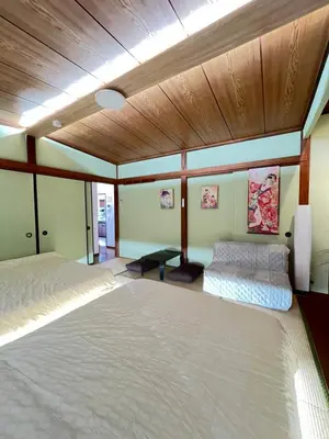 a bedroom with two beds and a wooden ceiling at Takara\u8c4a\u5cf6\u5712101 NR0434 in Tokyo