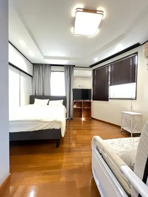 a large room with two beds and a tv at Takara\u8c4a\u5cf6\u5712101 NR0434 in Tokyo