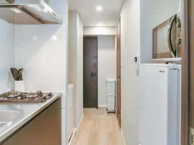 a white kitchen with a sink and a stove at Triphome Nakano 2025 Cozy in Tokyo