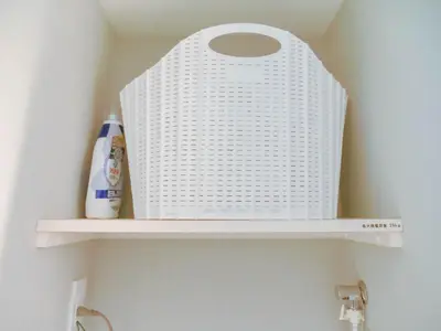 a white wicker basket on a shelf in a bathroom at Triphome Nakano 2025 Cozy in Tokyo