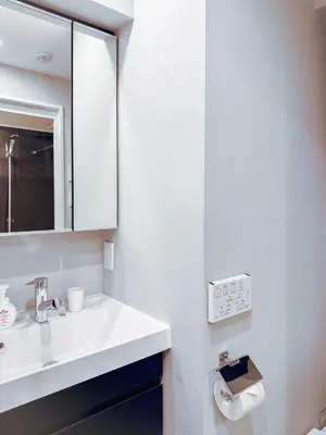 a white bathroom with a sink and a mirror at Triphome Nakano 2025 Cozy in Tokyo