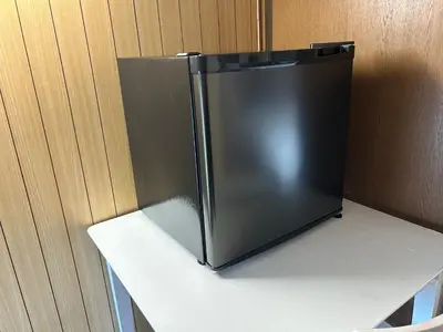 a black refrigerator sitting on top of a counter at 池袋 Cozy for 3-12guests 3BR House-3Showers &3Toilets in Tokyo