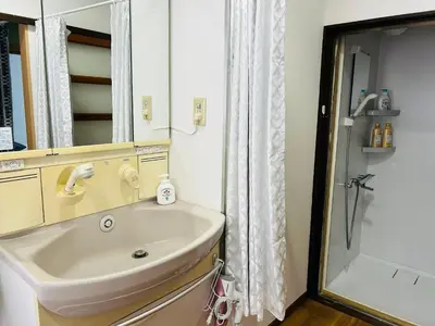 a bathroom with a sink and a shower at 池袋 Cozy for 3-12guests 3BR House-3Showers &3Toilets in Tokyo