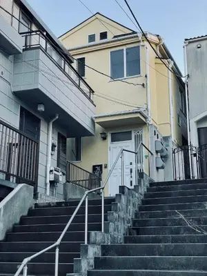 a building with stairs in front of a house at Takara\u8c4a\u5cf6\u5712201 NR0435 in Tokyo