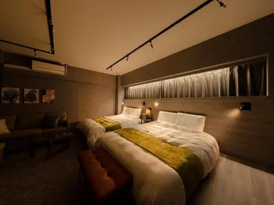 a hotel room with two beds and a couch at Akihabara Sta 13min, Kanda Sta 10min,Ogawamachi 2min,Hotel Prime Inn Kanda, in Tokyo