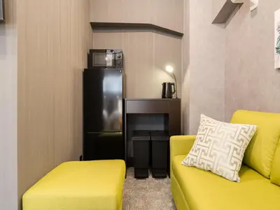 a room with two yellow couches and a tv at Akihabara Sta 13min, Kanda Sta 10min,Ogawamachi 2min,Hotel Prime Inn Kanda, in Tokyo