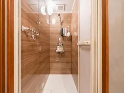 a shower with a glass door in a bathroom at Akihabara Sta 13min, Kanda Sta 10min,Ogawamachi 2min,Hotel Prime Inn Kanda, in Tokyo