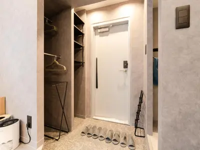 a bathroom with a white door and a bunch of shoes at Akihabara Sta 13min, Kanda Sta 10min,Ogawamachi 2min,Hotel Prime Inn Kanda, in Tokyo