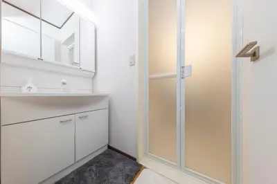 a bathroom with a glass shower and a sink at Sakura in Tokyo