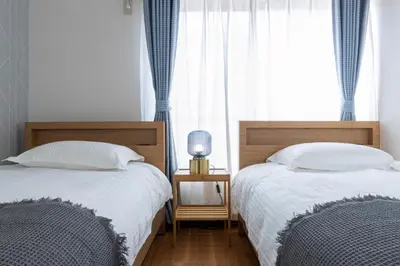 two beds sitting next to each other in a bedroom at Sakura in Tokyo